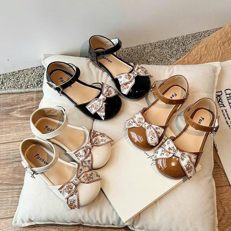Giầy Sandal Bít Mũi Nơ Vải Thổ Cẩm Mã 010 Cho Bé Xinh Xắn, Phối 3 Màu Nâu, Kem, Đen Da Mềm