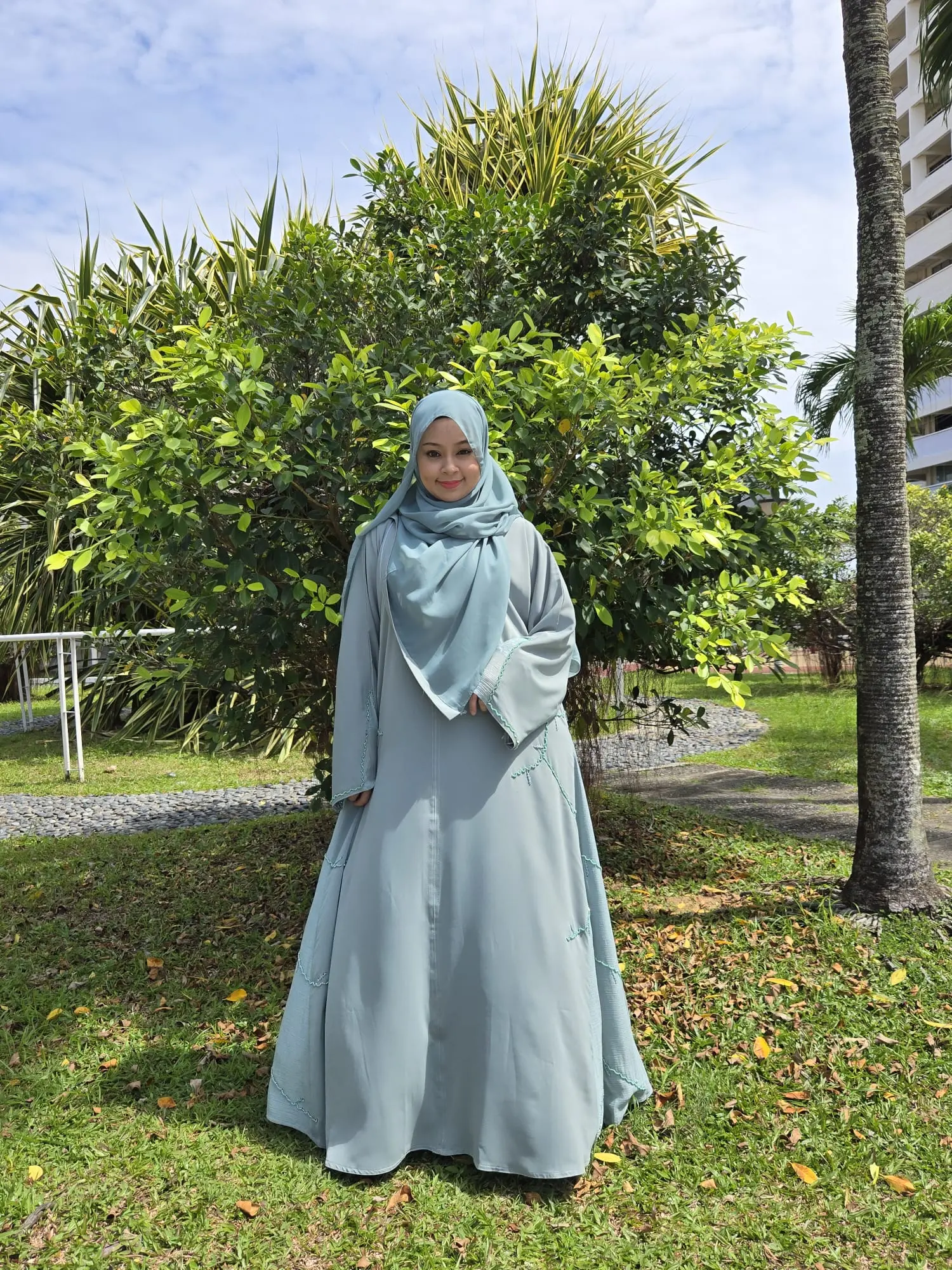 Soft Pastel Green Flowy Abaya with Intricate Embellishments from Dubai