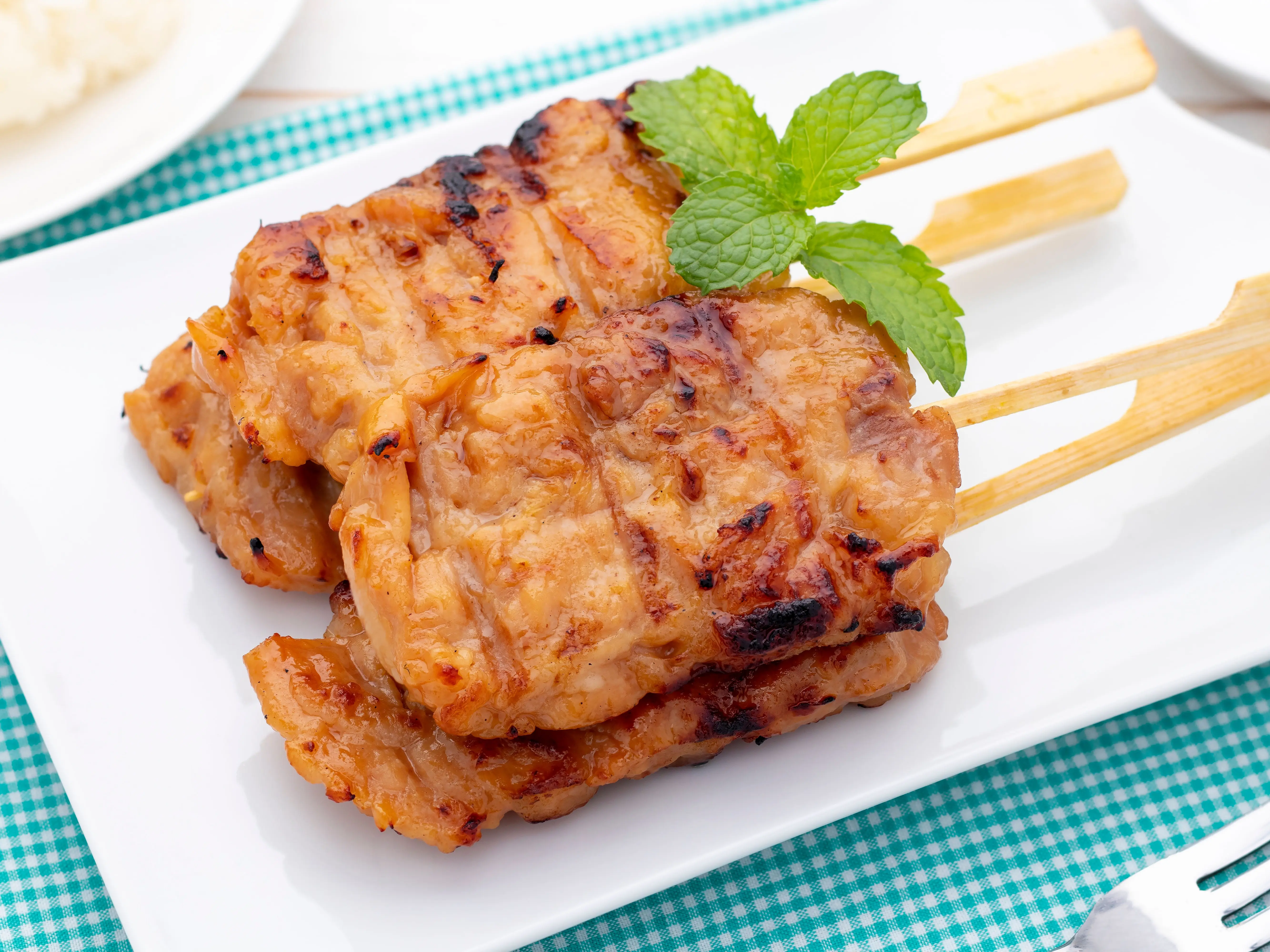 Moo Ping offering you the delicious, smoky, and savory flavors of perfectly grilled pork skewers anytime, anywhere.