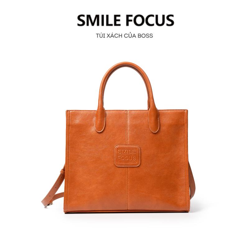 Túi xách da bò SMILE FOCUS dáng túi tote công sở phong cách Châu Âu sang trọng, thời thượng. Phù hợp đi làm, đi chơi, dịp khác. Túi basic công sở kèm dây đeo vai, 2 kiểu đeo. Xách tay/ đeo chéo. Size 31cm - SF3338