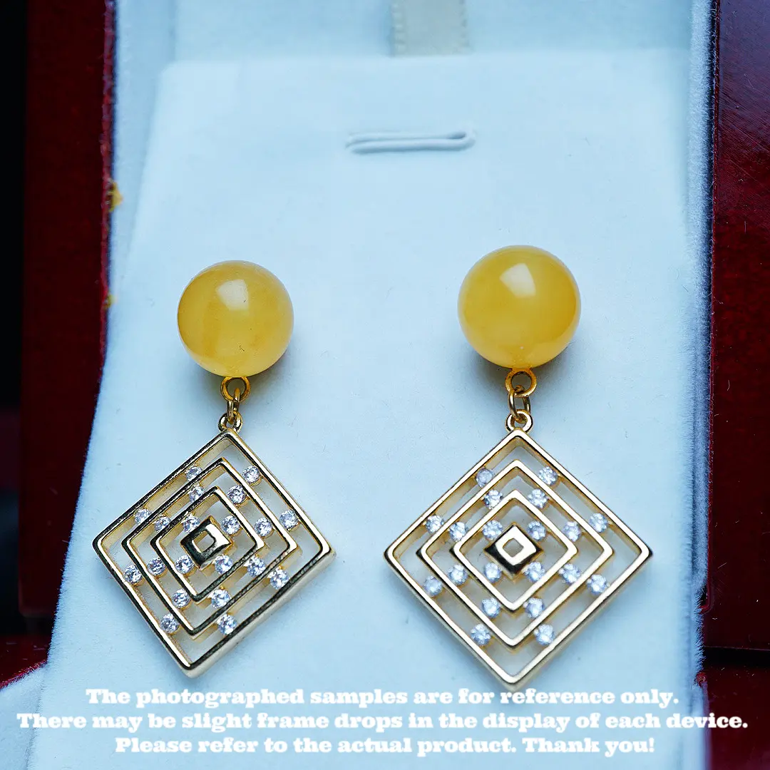 These are a pair of ear pendants made of natural raw ore amber and beeswax.