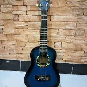 Yamaha Ukulele Gitar Original dengan Desain Warna Biru dan Latar Belakang Dinding Batu