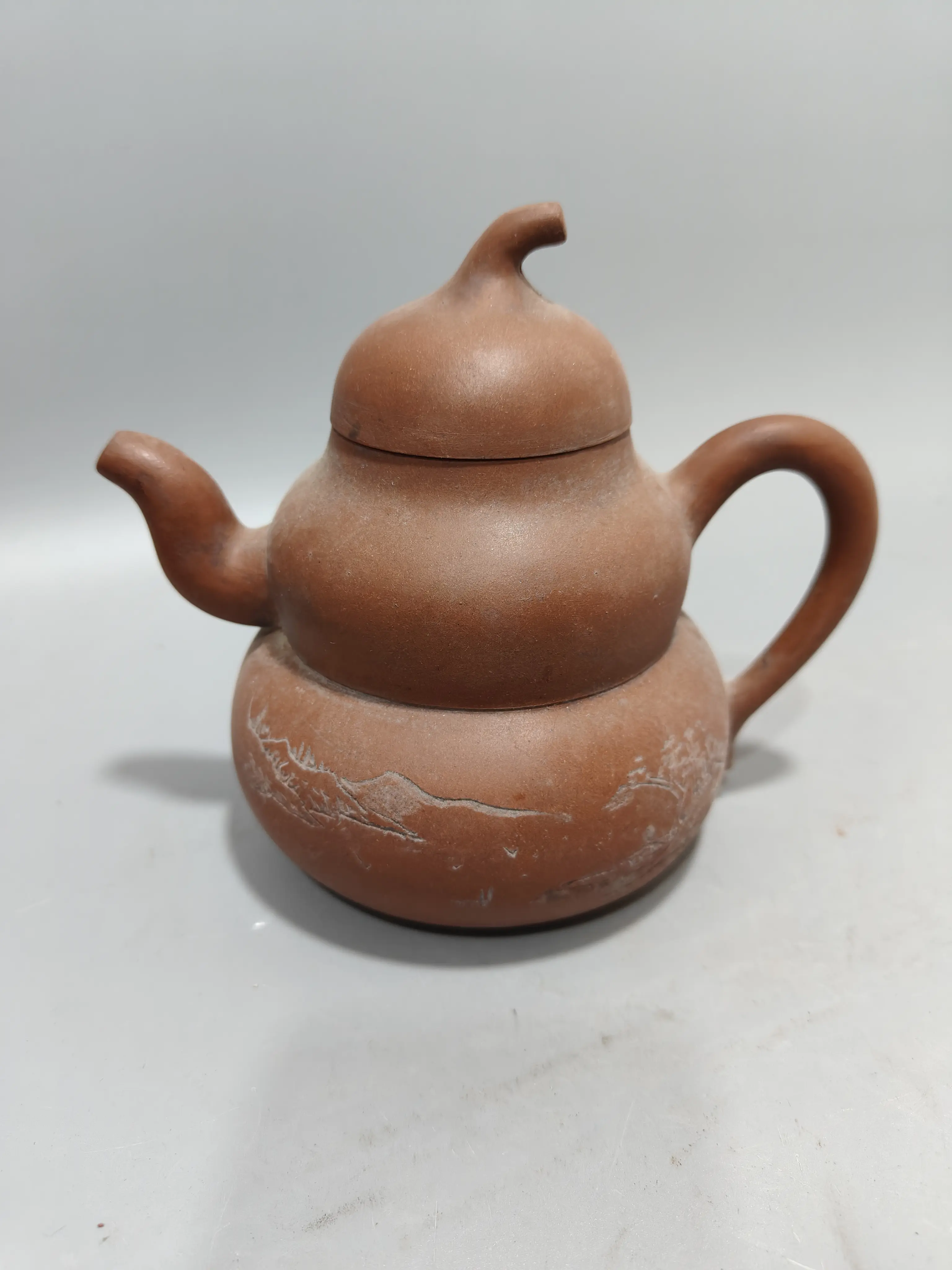 Folk collection of old objects gourd shaped purple clay teapot.