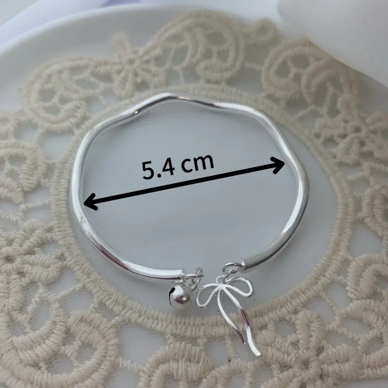 Vòng tay nữ mạ bạc 999 charm chuông nơ Natalia Jewelry 1