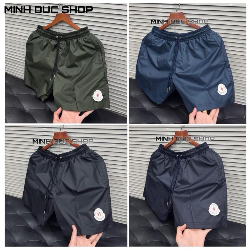 Quần Gió Màu Đen Và Xanh Than Hình Logo Trắng Thêu Mũi Tên Đỏ MDMCLE001