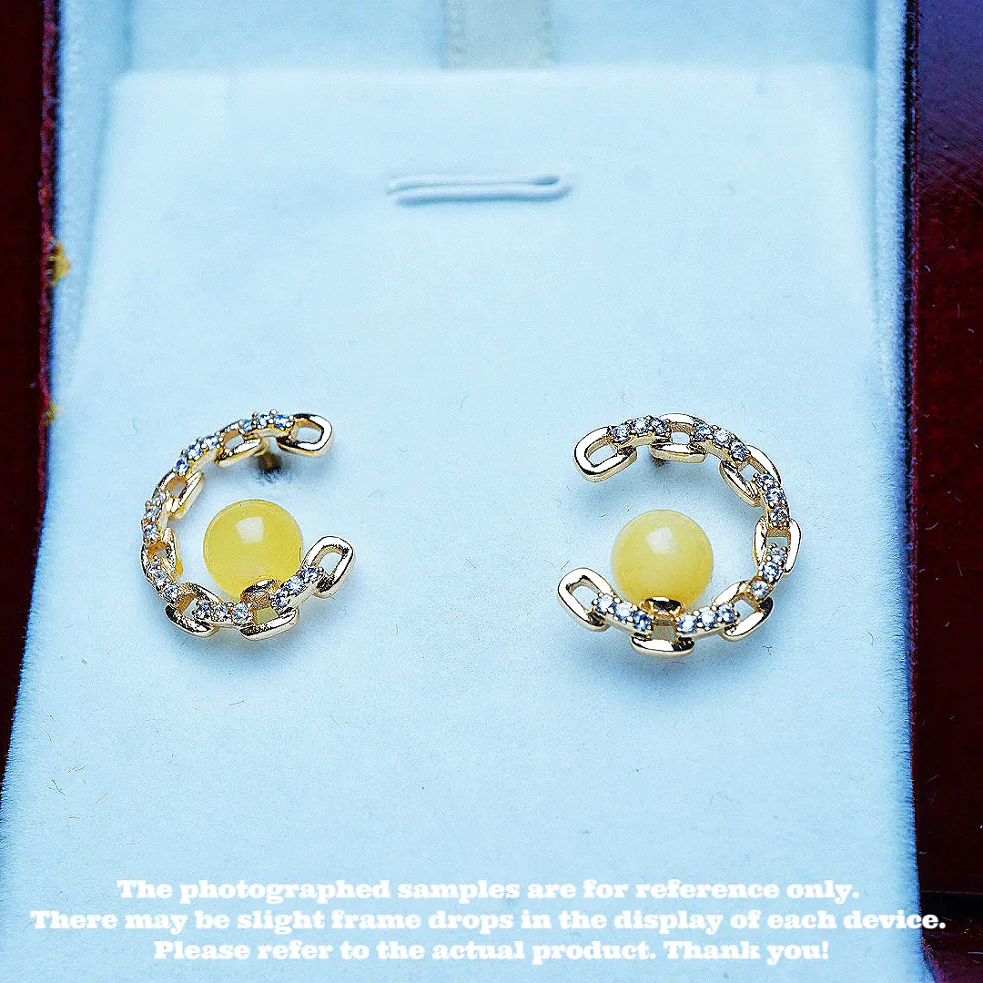 These are a pair of ear pendants made of natural raw ore amber and beeswax.