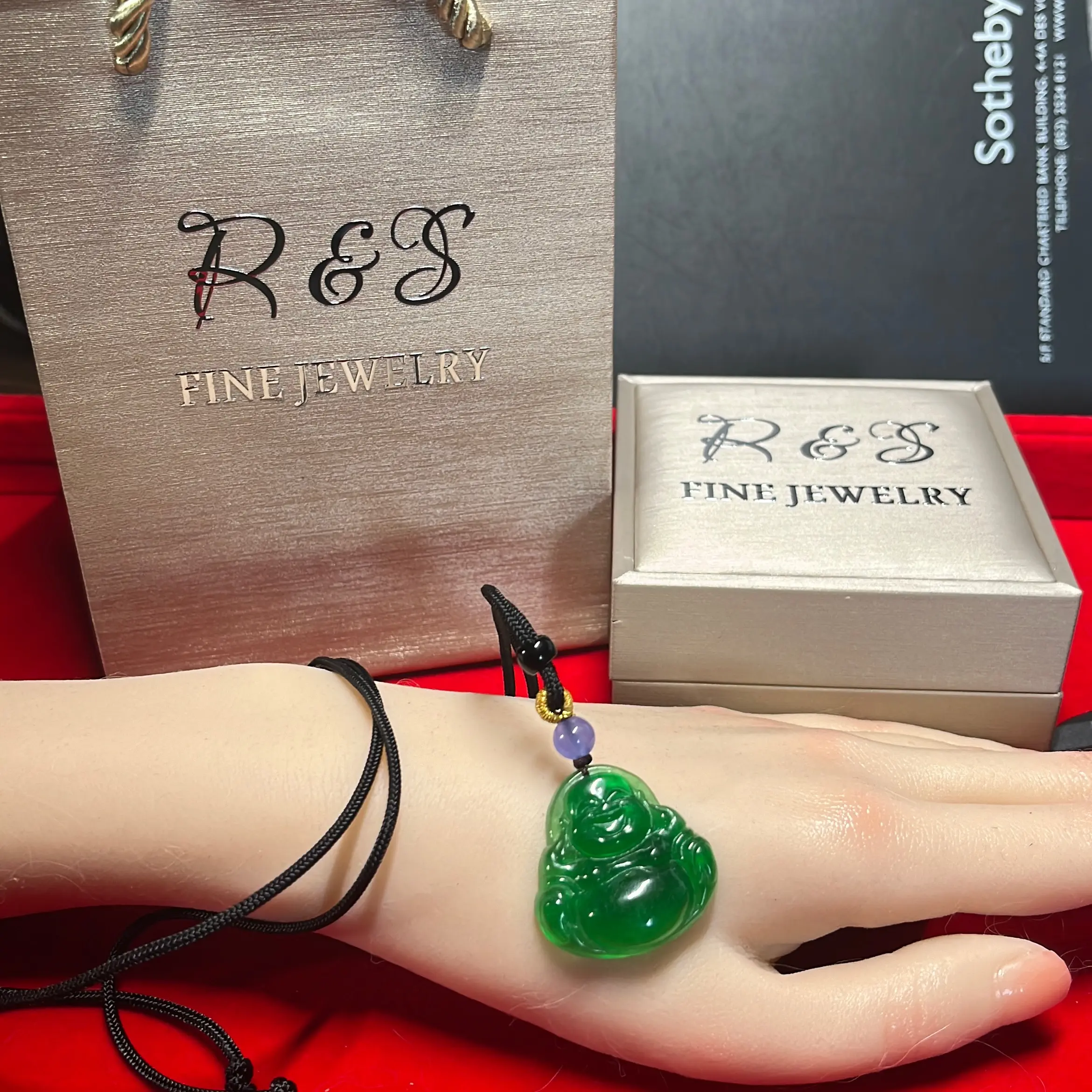 274. Green jadeite Buddha pendant with black rope