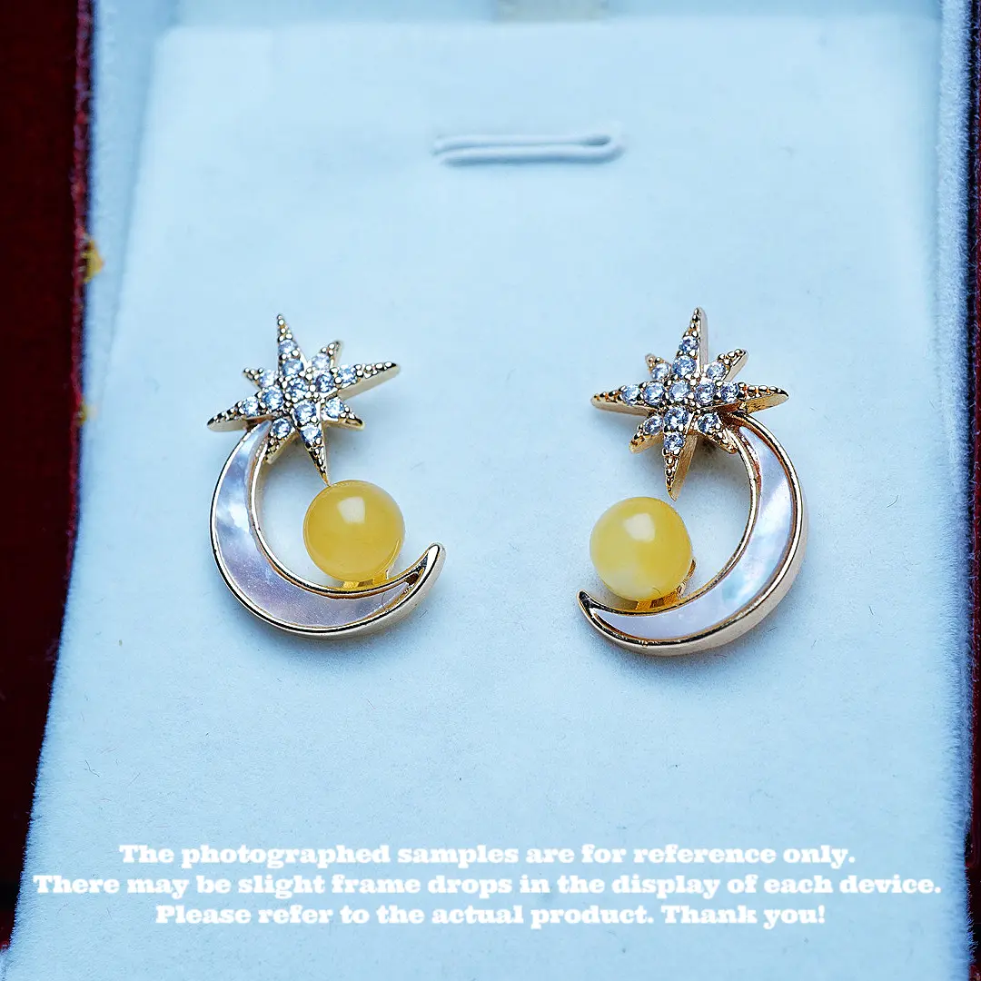 These are a pair of ear pendants made of natural raw ore amber and beeswax.