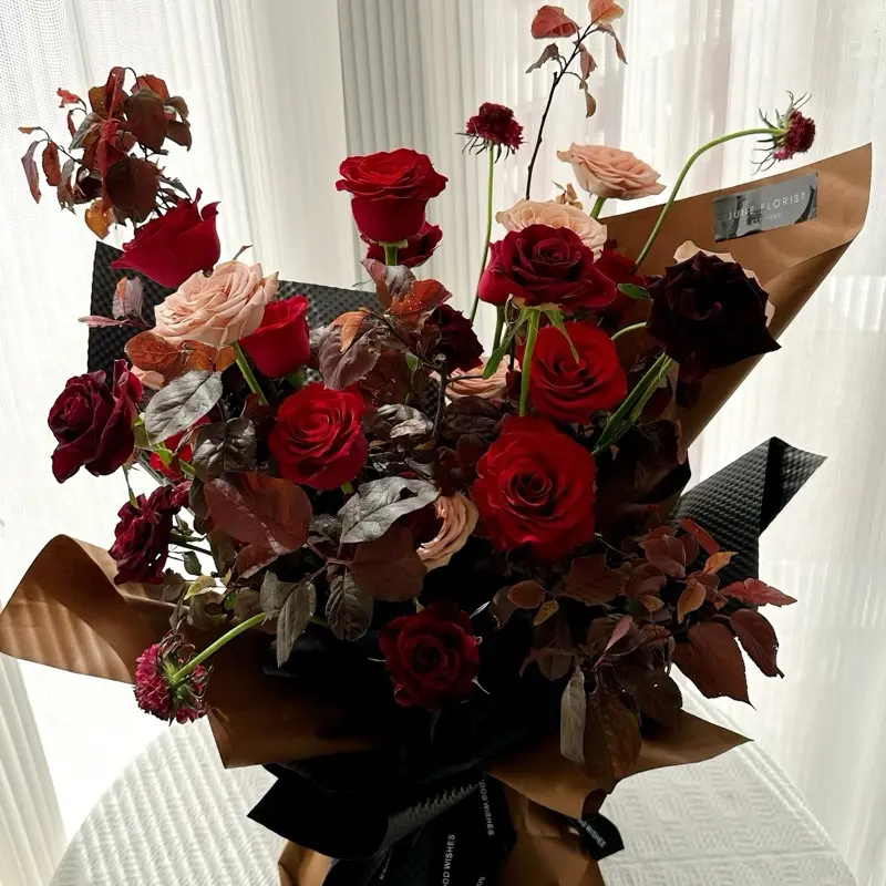 June Florist Hand Bouquet Red Roses with Eustoma Blooms