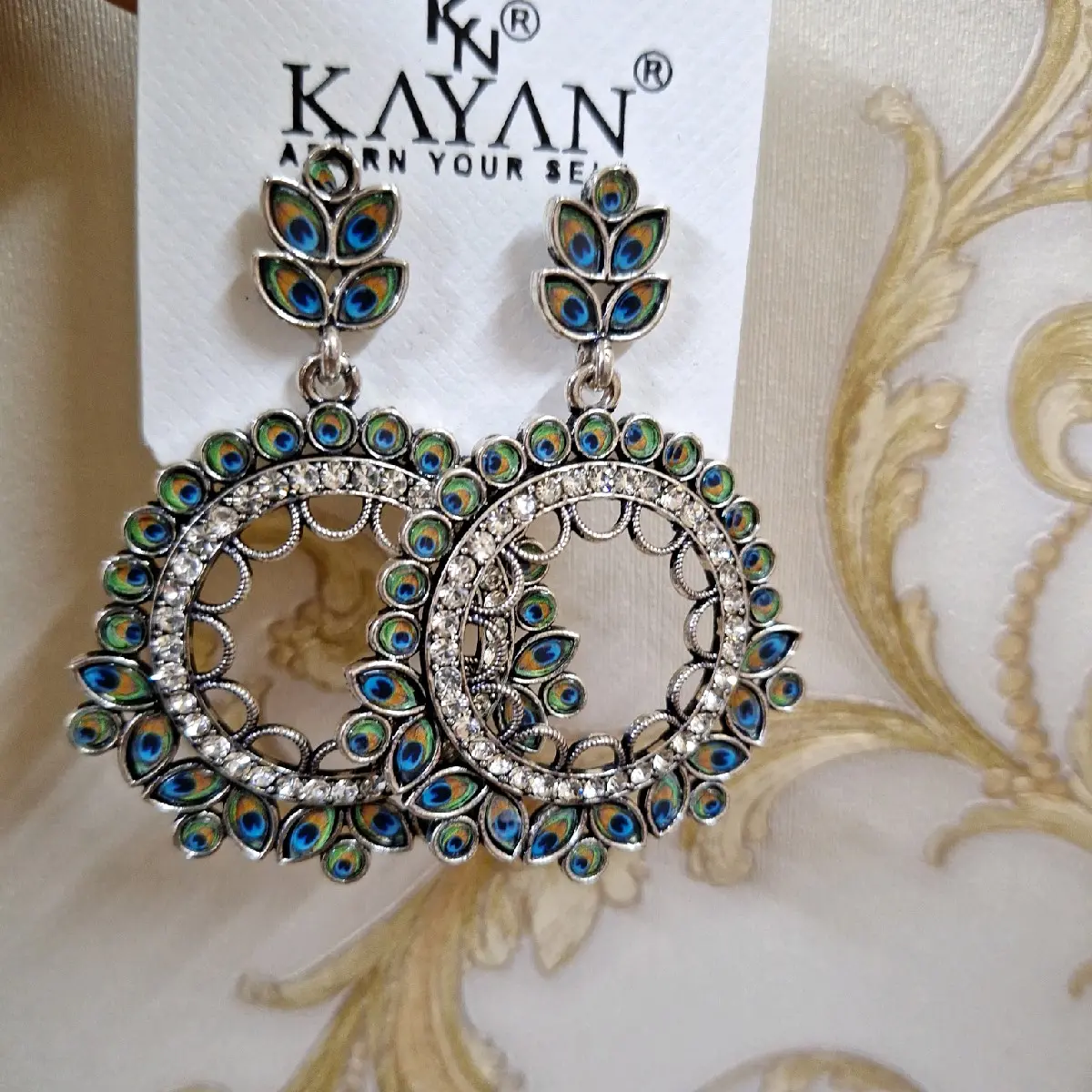 Beautiful kayan peacock earrings silver colours