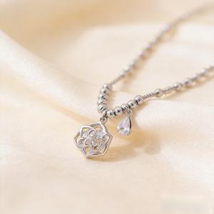 Silver necklace adorned with camellia flowers and water droplets, featuring a CZ Beauty pendant | Lightweight collarbone necklace