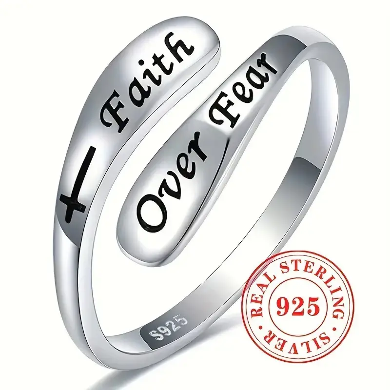 A silver adjustable ring with the message "Faith Over Fear" in a vintage minimalist style.