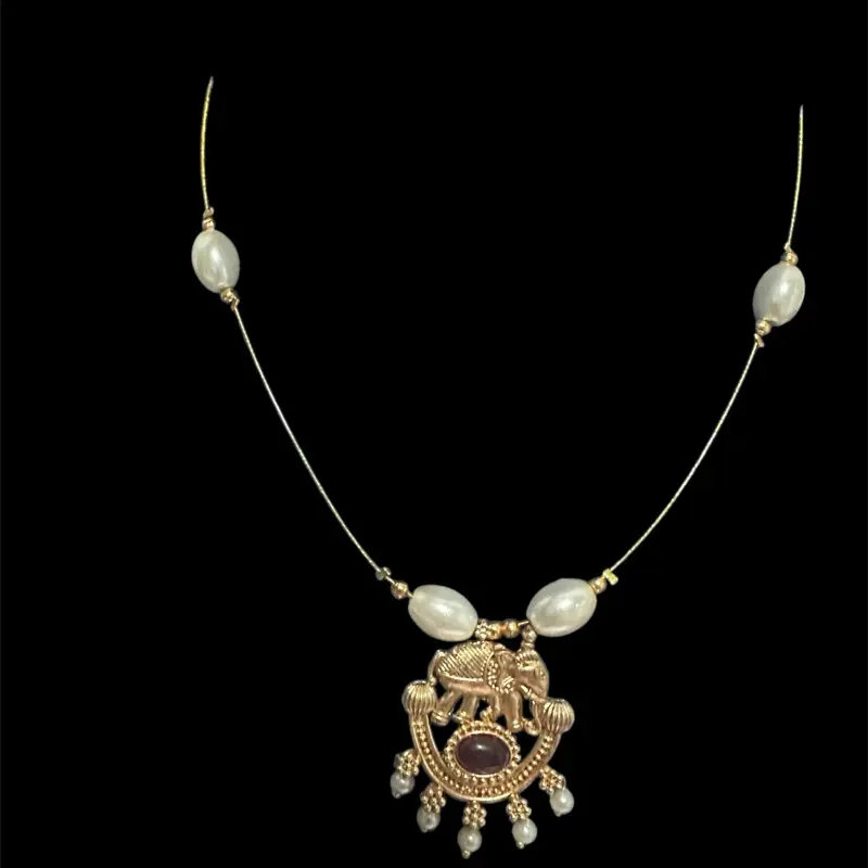 Elephant pendant invisible necklace in ruby with pearls