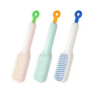 Auto-Cleaning Static-Free Hair Comb with Retractable Bristles Packaged by OOP Bag Blue Green